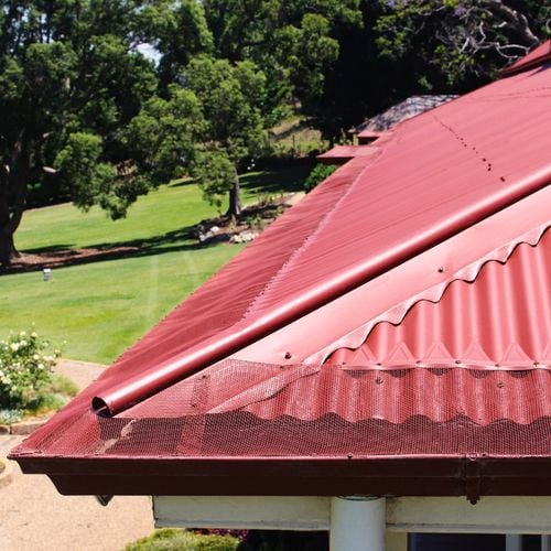 Close up of a roof with an installed gutter mesh.