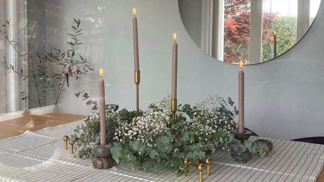 Christmas wreath on table with candles throughout
