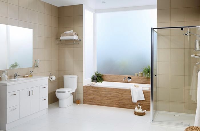 Bathroom with a white and beige colour scheme. There is a bath, shower and sink in shot.