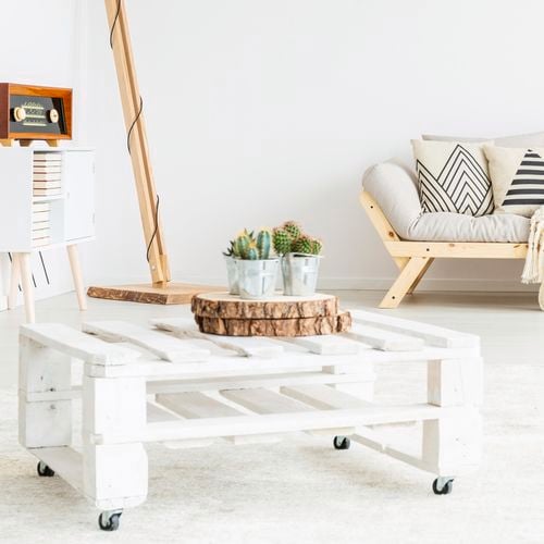 White pallet coffee table with wheels.