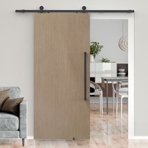Living and dining interior featuring Rolltrak Matte Black Top Mount Barn Door Track, 600mm Matte Black Round Single Pull Handle and Matte Black Barn Door Guide.