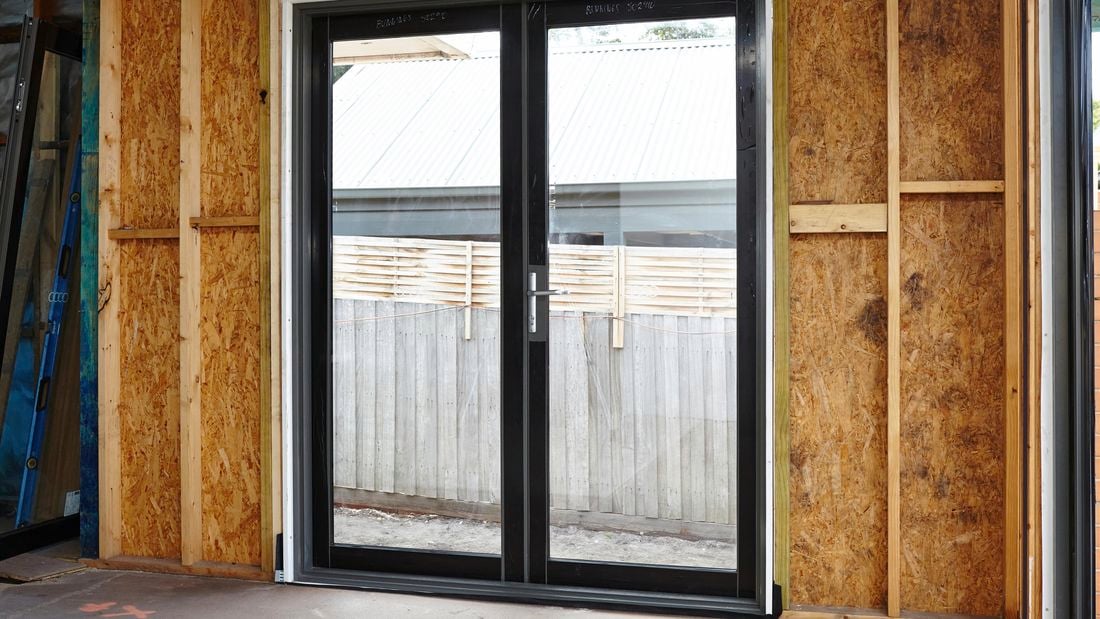 French doors installed into a house still under construction