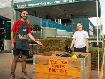 Recycle your plastic plant pots with us team with sign 