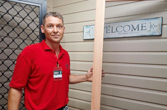 Bunnings team member Glen holding a length of hardwood