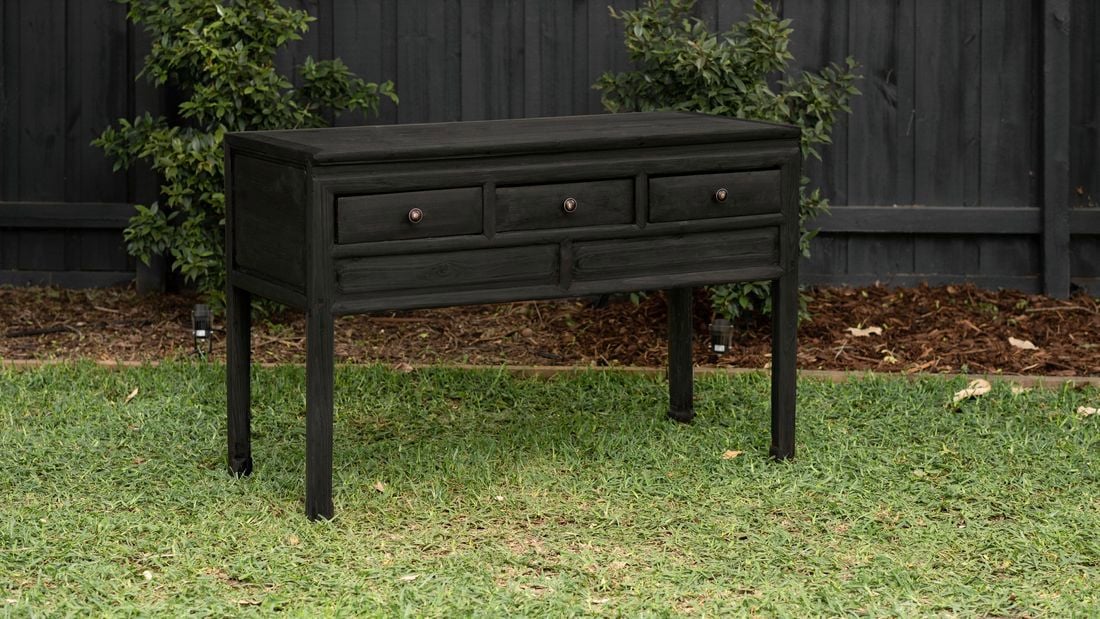 stained table in a backyard
