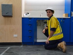 AFLW star Jasmine Garner in a hi-vis shirt while training as an apprentice plumber