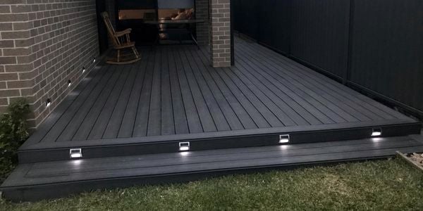 A decking with deck lights and an undercover area.