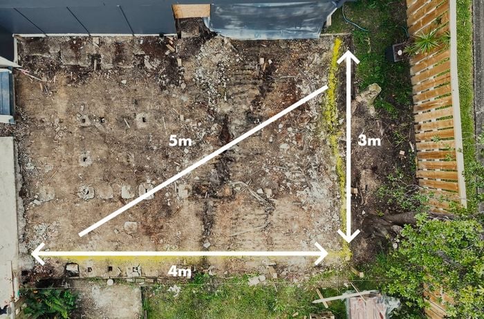 Birds eye view looking into a back garden that is preparing to build a timber deck