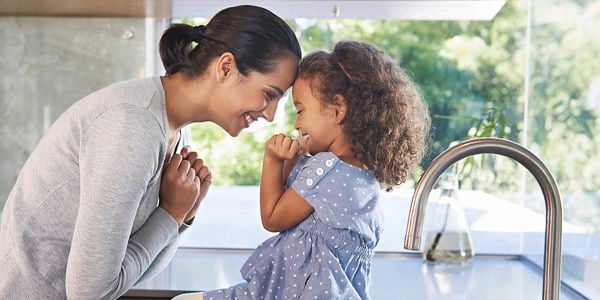 Mother and daughter smiling at each other.