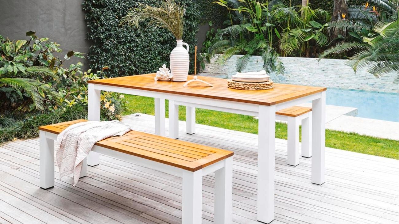 Outdoor dining setting near pool area.