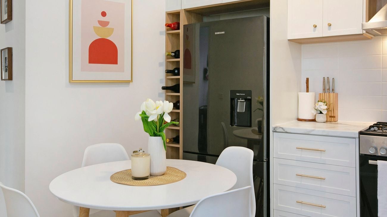 An after picture of the renovated kitchen in white and wooden accent.