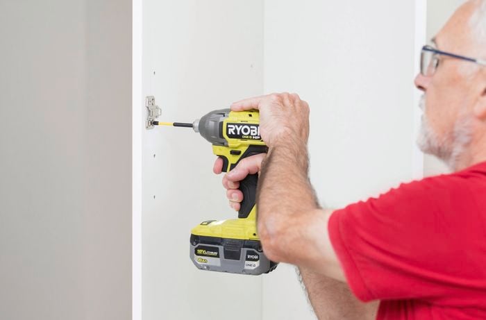 Attach the hinge plates using a cordless drill