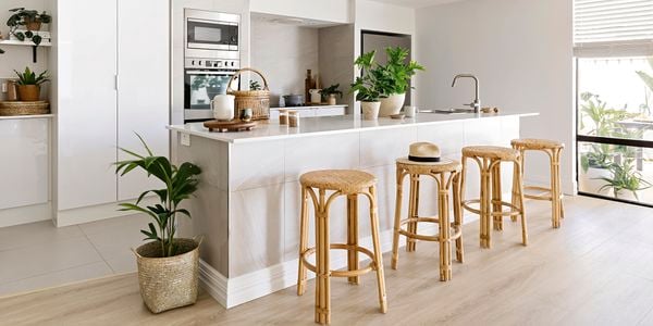 Modern kitchen with island benchtop and wooden stools