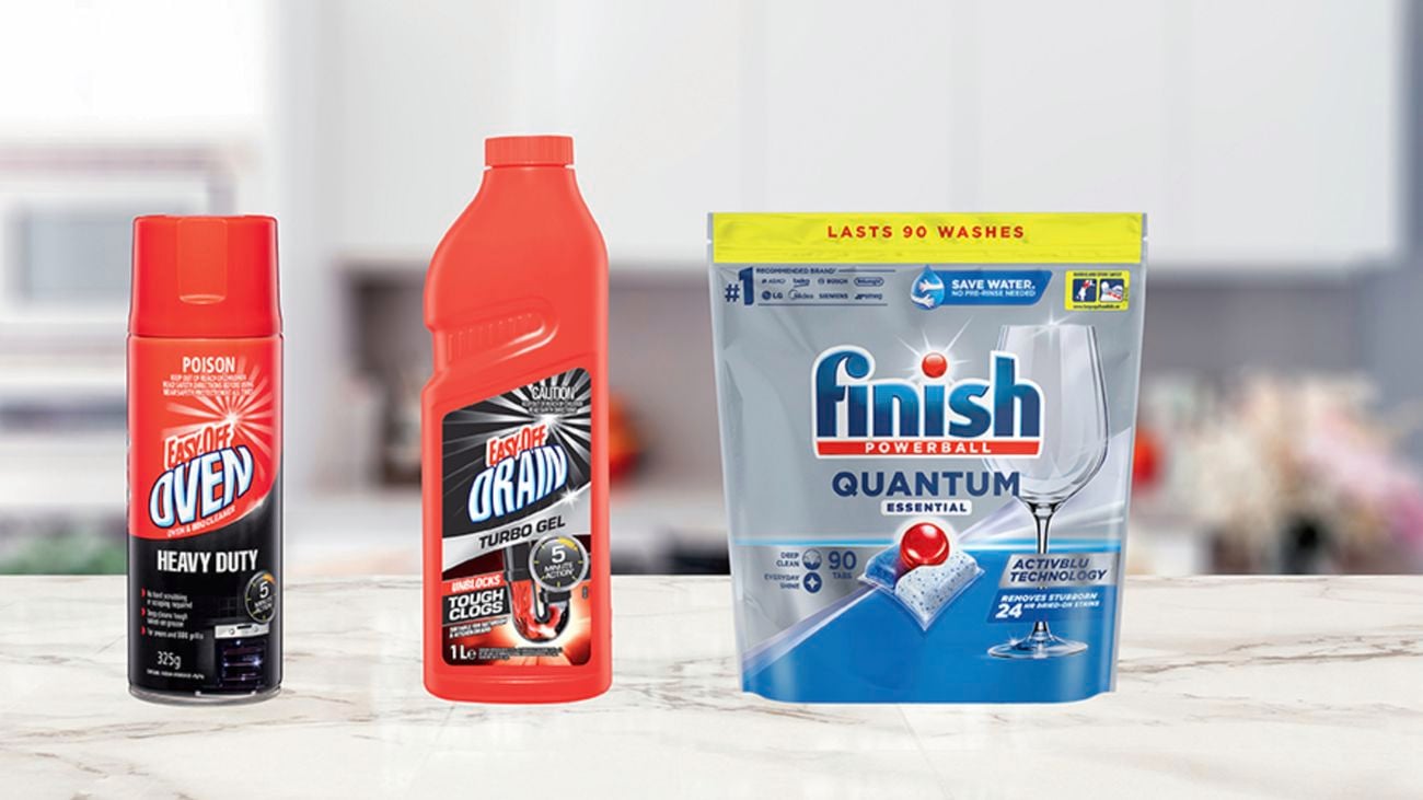 Cleaning products sit on a kitchen benchtop.