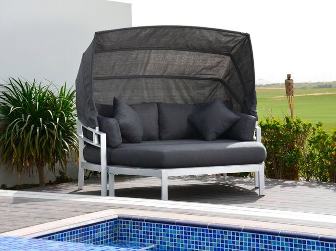 A cast aluminium outdoor dining setting with four chairs and a table