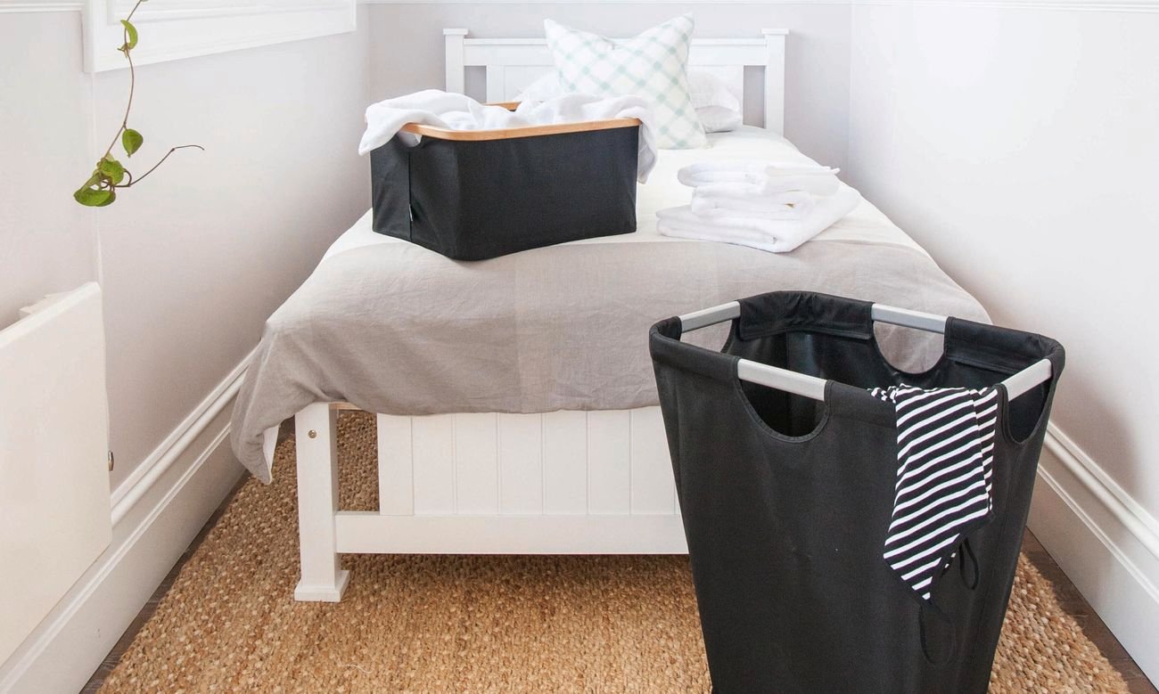 Two washing baskets and a bed in a modern bedroom