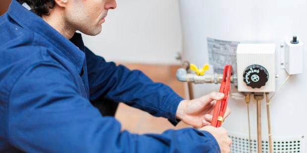 Plumber fixing a hot water heater