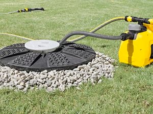 Yellow pool pump on green lawn