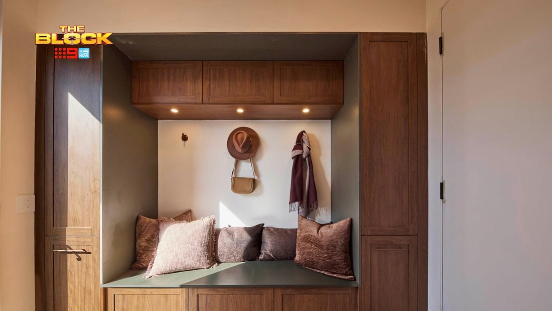 Mudroom nook from The Block with timber cabinetry, built-in bench, cushions, and wall hooks.