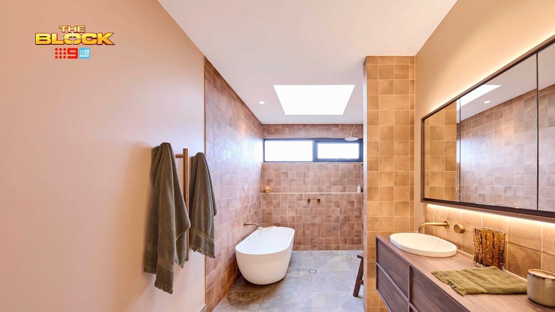 Natural coloured brown bathroom with timber vanity with towel rails and bath