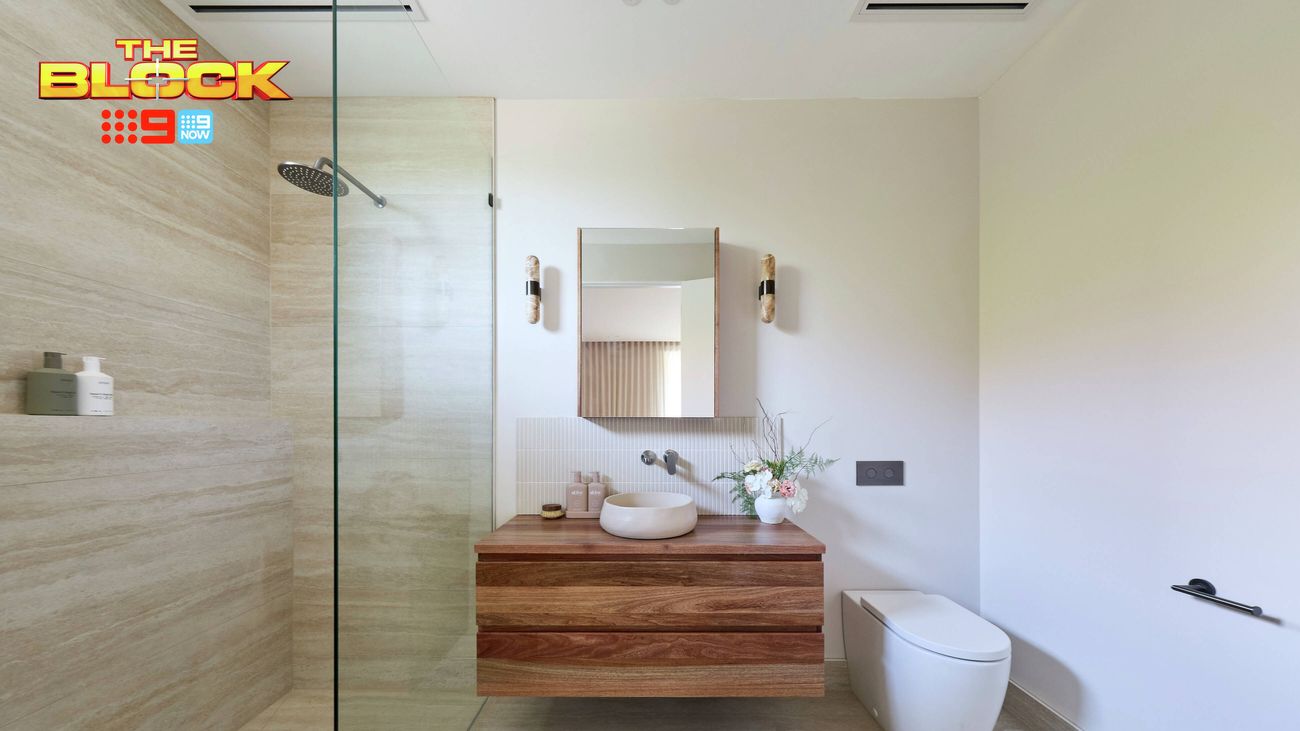 Contemporary ensuite featuring a walk-in shower, timber vanity with round basin, mirrored cabinet and wall-mounted toilet.