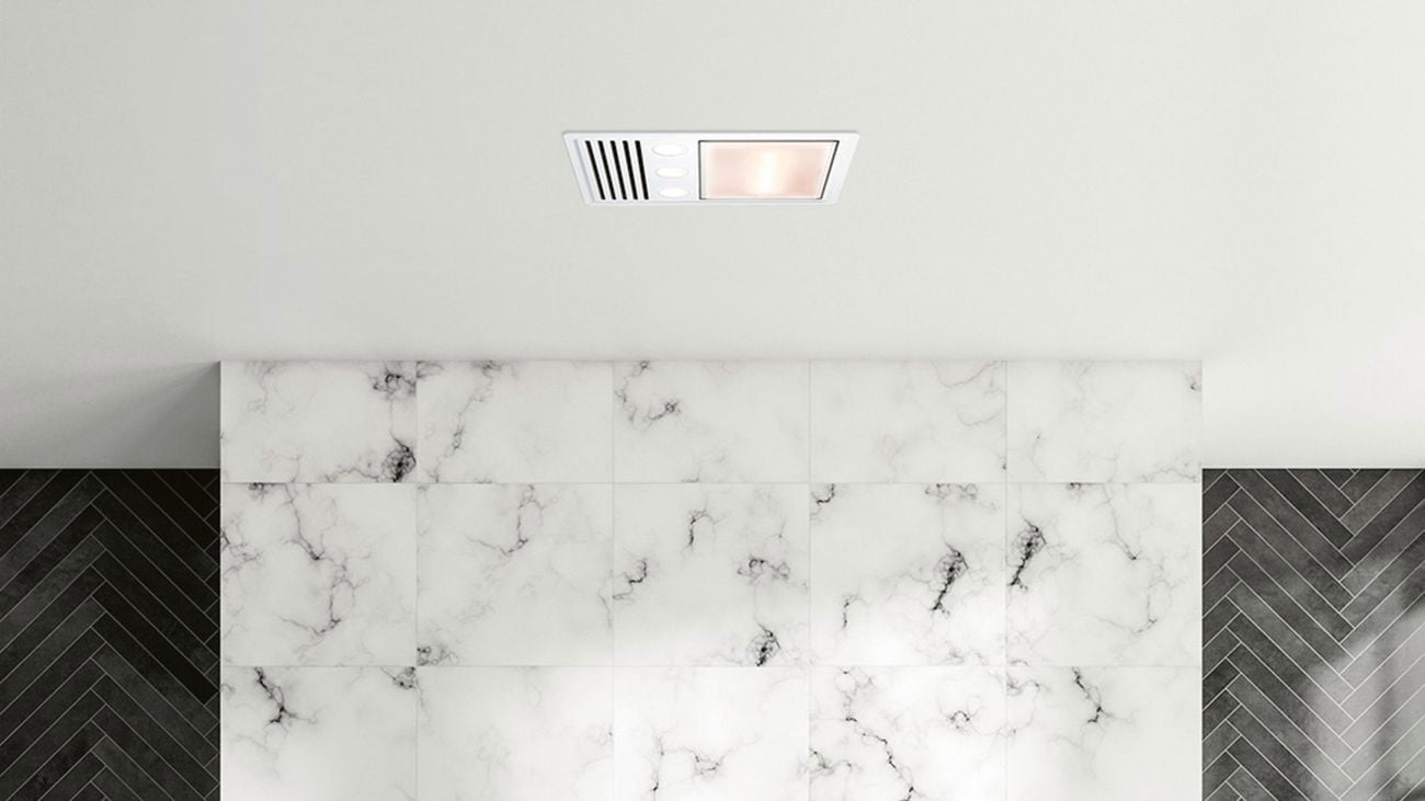 Bath with gold tapware and marble floor and wall