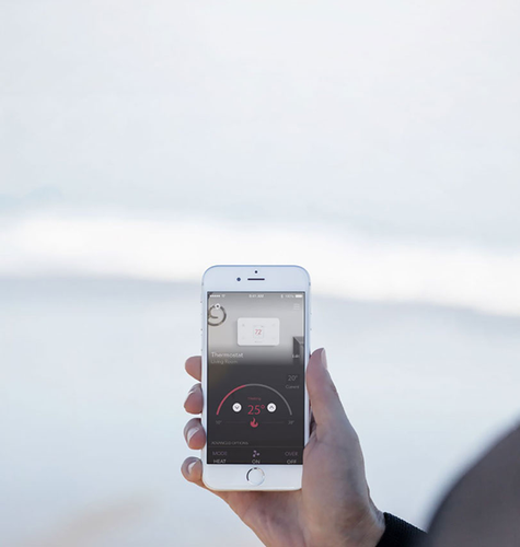 Person viewing app connected to home thermostat