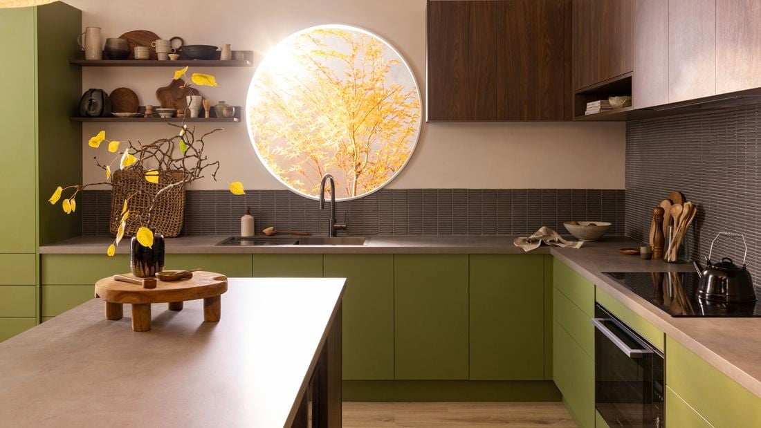 Kitchen with hardwood floor and wooden island, kitchen cupboards painted dark green