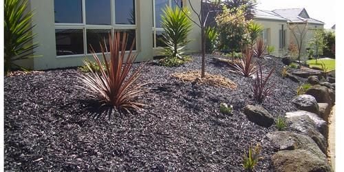 Front yard that has been done with sand soil mulch and some stone 