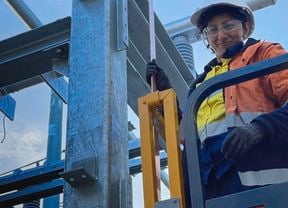 Women in construction advocate Faiza Nazar, a female electrical apprentice, dressed in hi vis workwear and full PPE