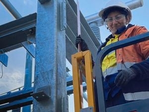 Women in construction advocate Faiza Nazar, a female electrical apprentice, dressed in hi vis workwear and full PPE