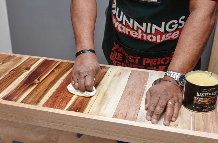Person waxing the table