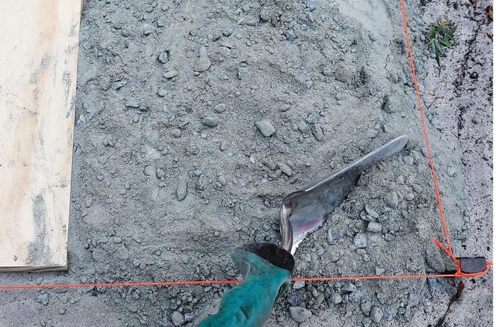 A string outline for a paver, filled in with a mix concrete and road base