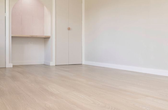 A room with new light laminate flooring 