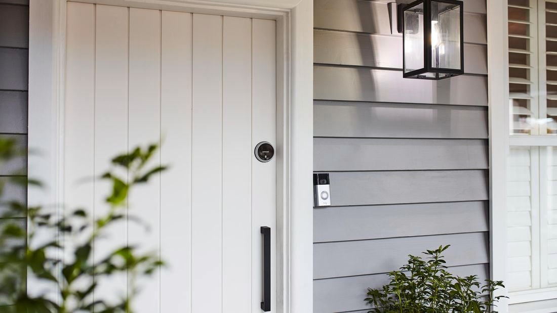 White front door in a blue weatherboard house.