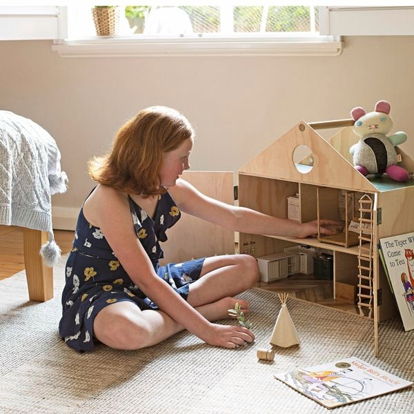 Girl with dolls' house