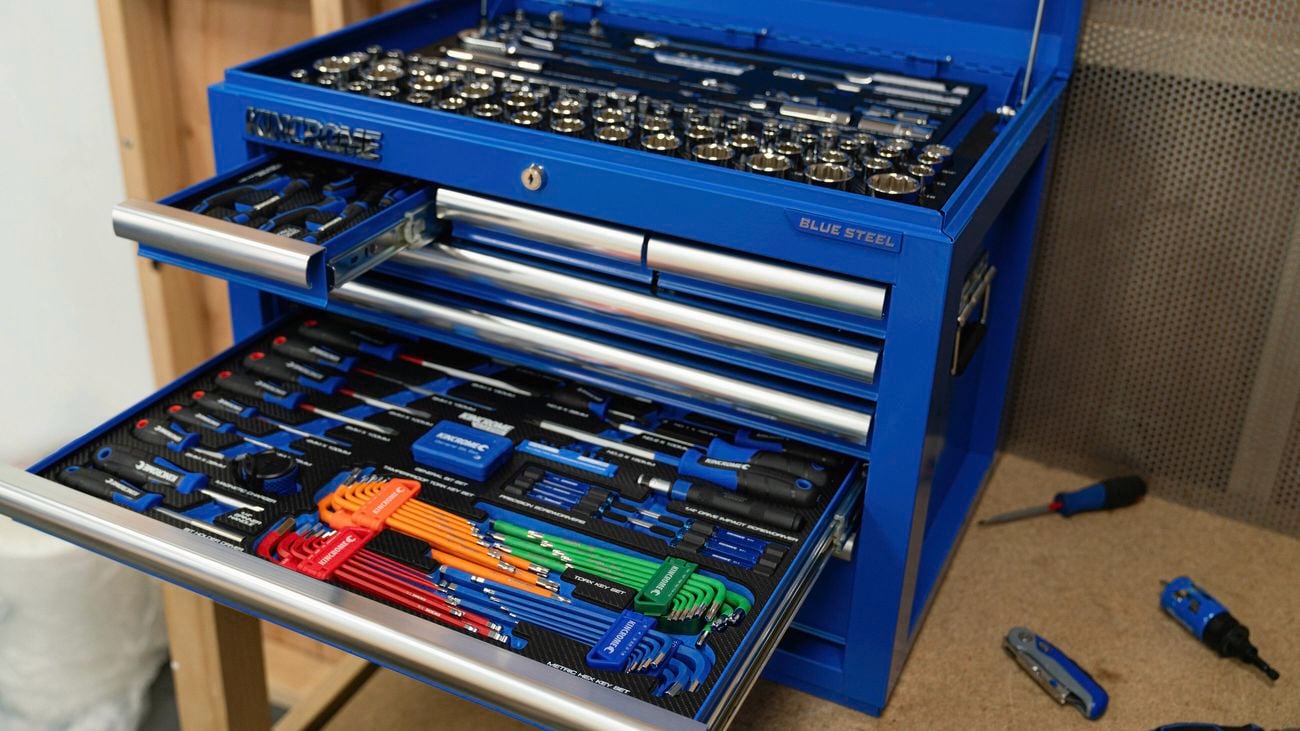 Blue kincrome steel tool storage unit with opened draws