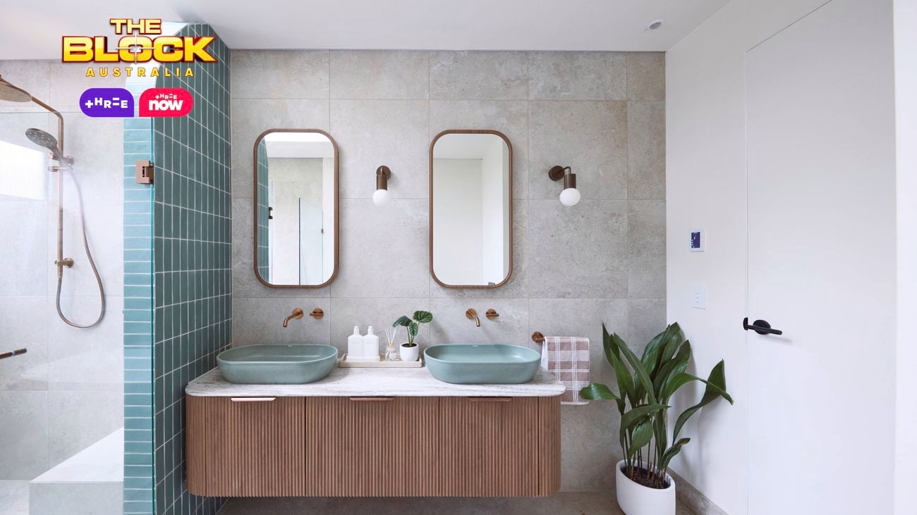 Blue and white bathroom with blue oval basins on a brown timber vanity with a fluted profile