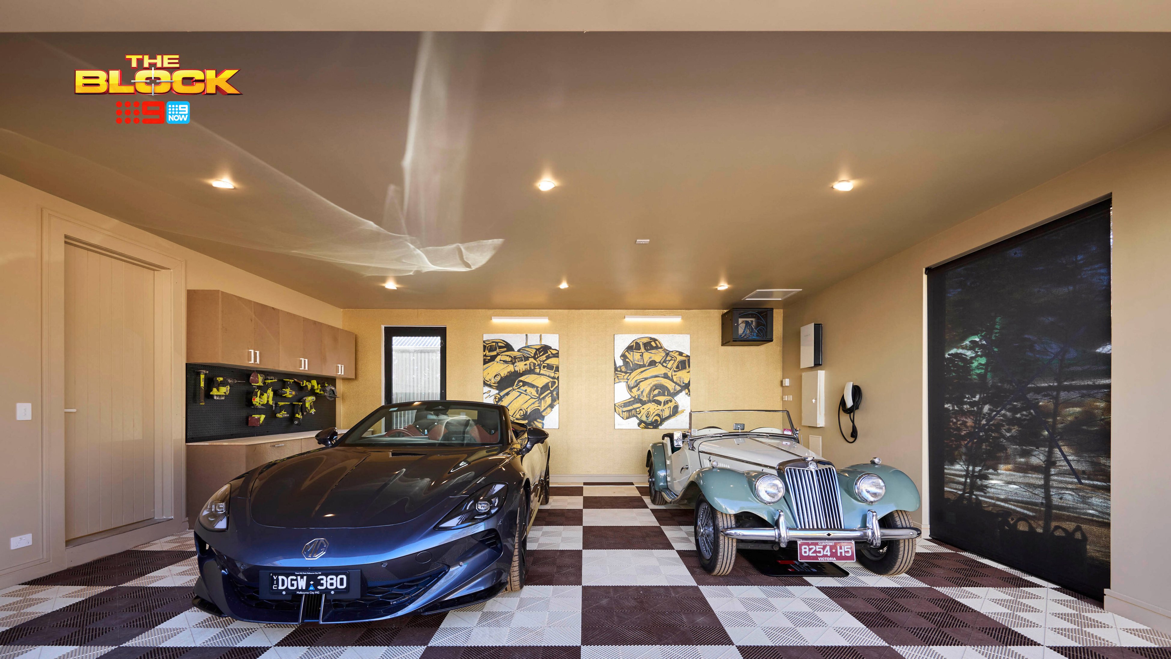 Garage from The Block with patterned flooring, storage cabinetry, and two luxury cars.