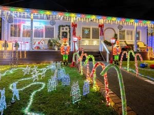 Front of house decorated with Christmas lights and decorations.