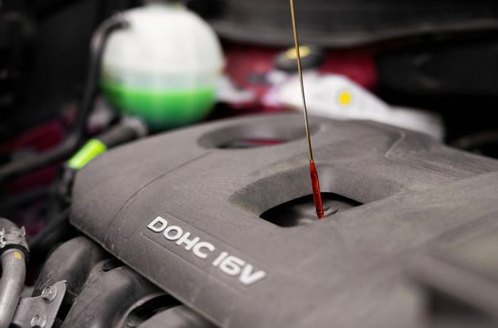 An image shows a close-up of the car engine shows the dipstick in place, with the oil appearing fresh and in good condition. 