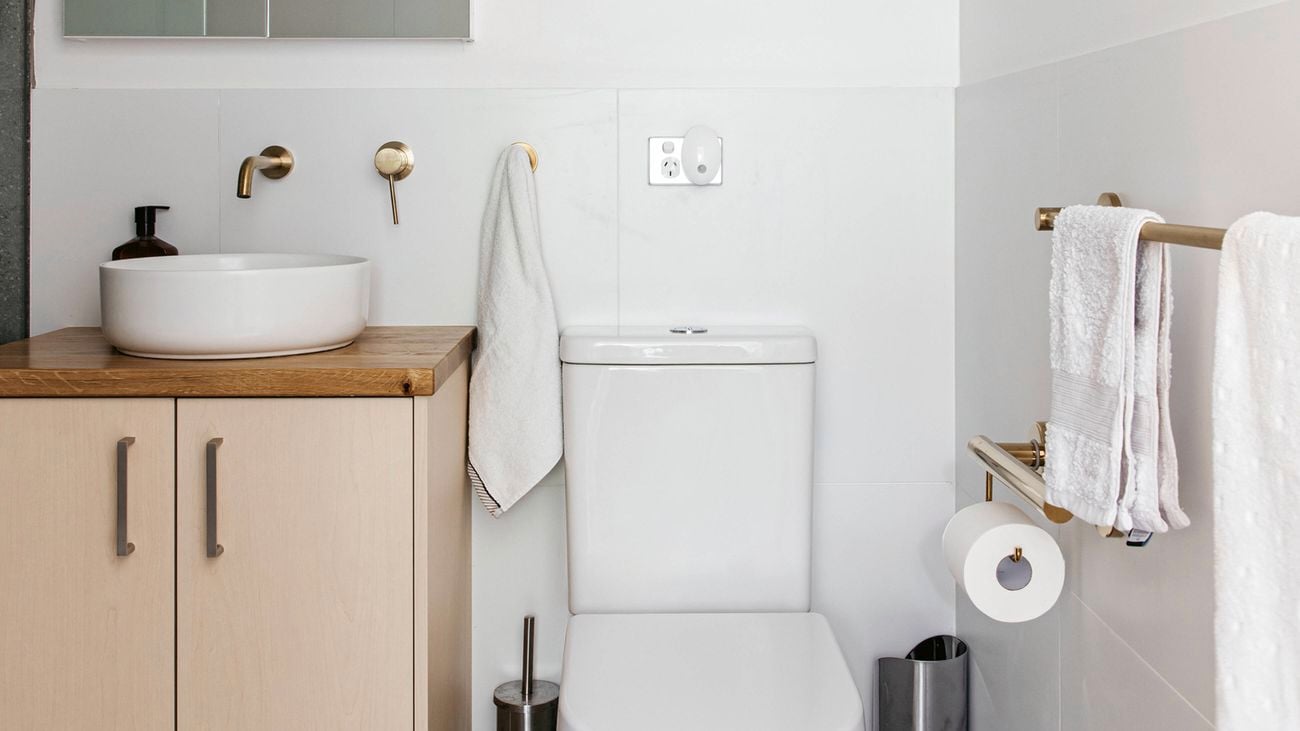 A bathroom with assisted living design elements including handrails and accessible features