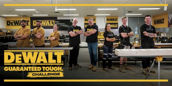 DEWALT team members in a workshop. Banner promoting the DEWALT ANZ YouTube channel with text: "Watch Now - DEWALT ANZ YouTube". DEWALT Guaranteed Tough Challenge logo shown.