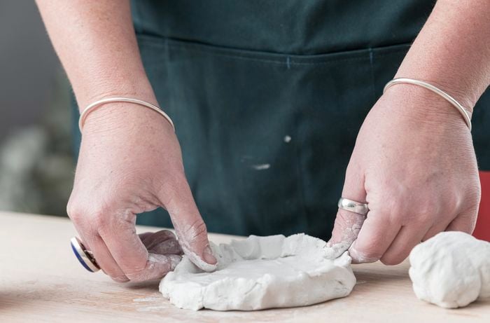 Clay being shaped into the form of a monster head