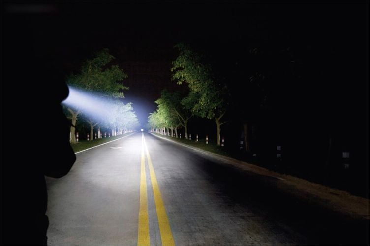 Person using torch to light up street