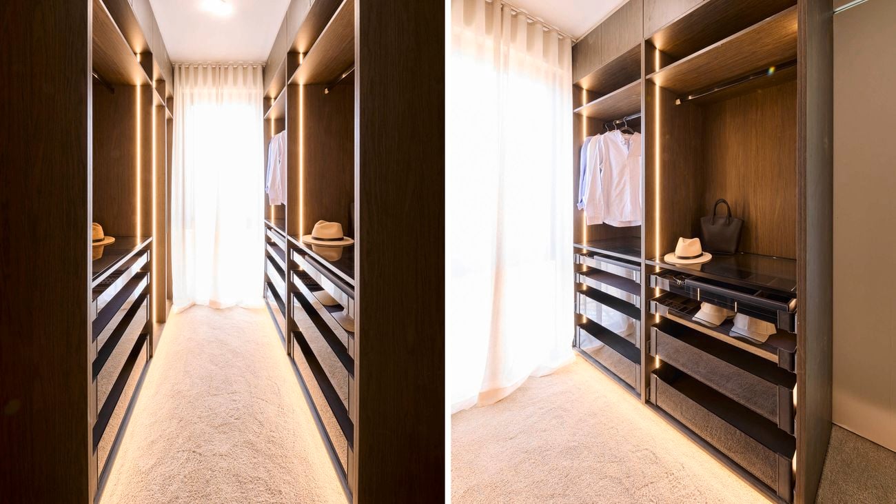 Both views show a narrow walk in wardrobe, carpeted hallway with wooden shelving units on either side. The left image displays closed drawers and shelves, while the right image reveals open drawers with hanging clothes and accessories such as hats and bags. Natural light enters through sheer curtains at the end of the hallway.