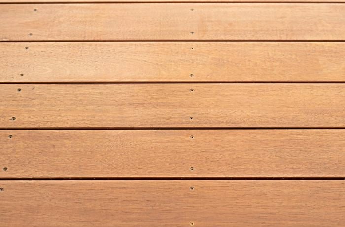 The timber deck is shown after the sanding process has been completed and the dust removed.