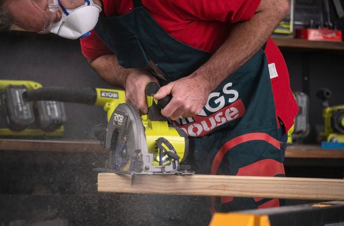 Using a power tool to cut leg cross-rails and braces
