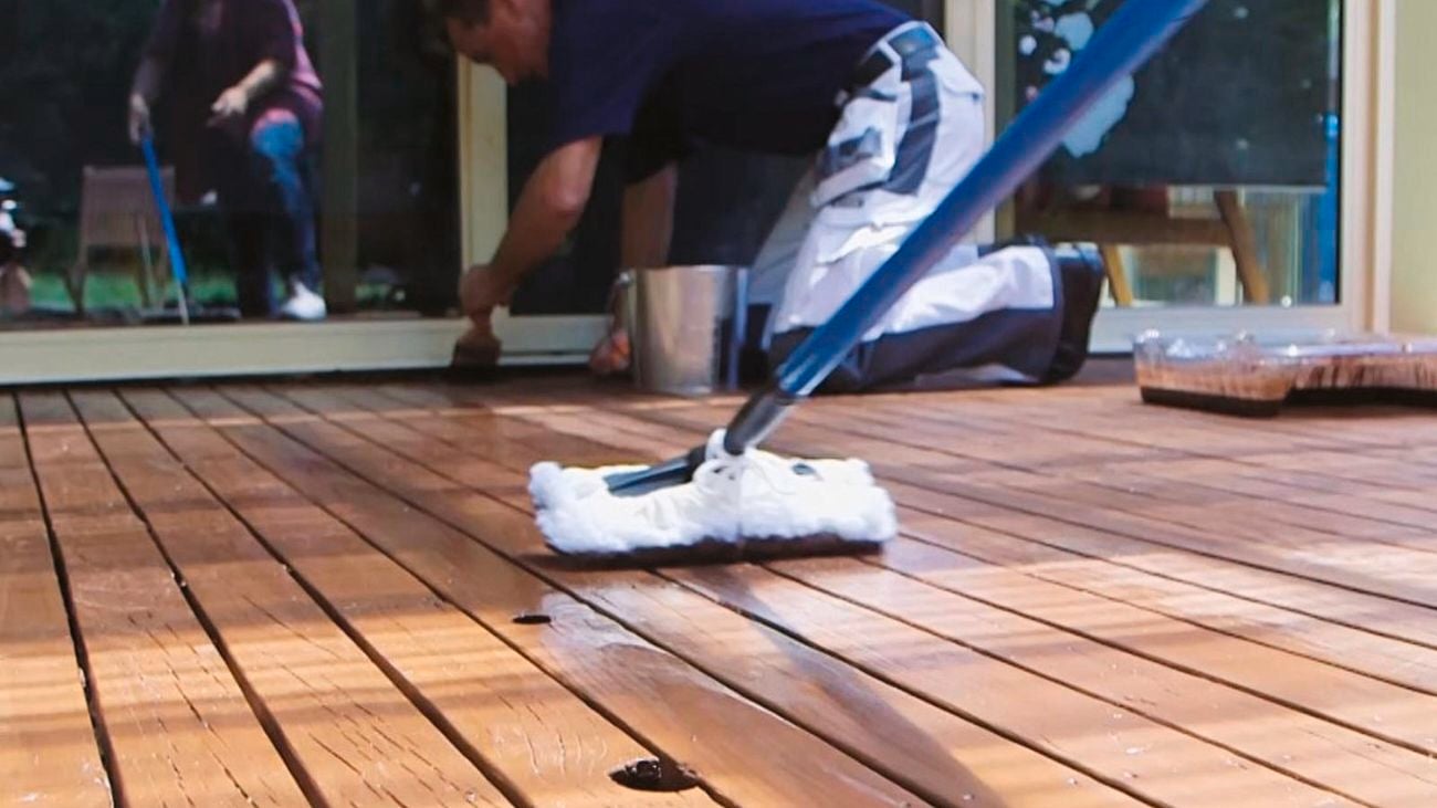 Second coat of decking oil being applied with lambswool applicator.
