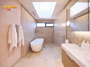 Natural coloured bathroom with a timber fluted profile vanity and marble benchtop and bath